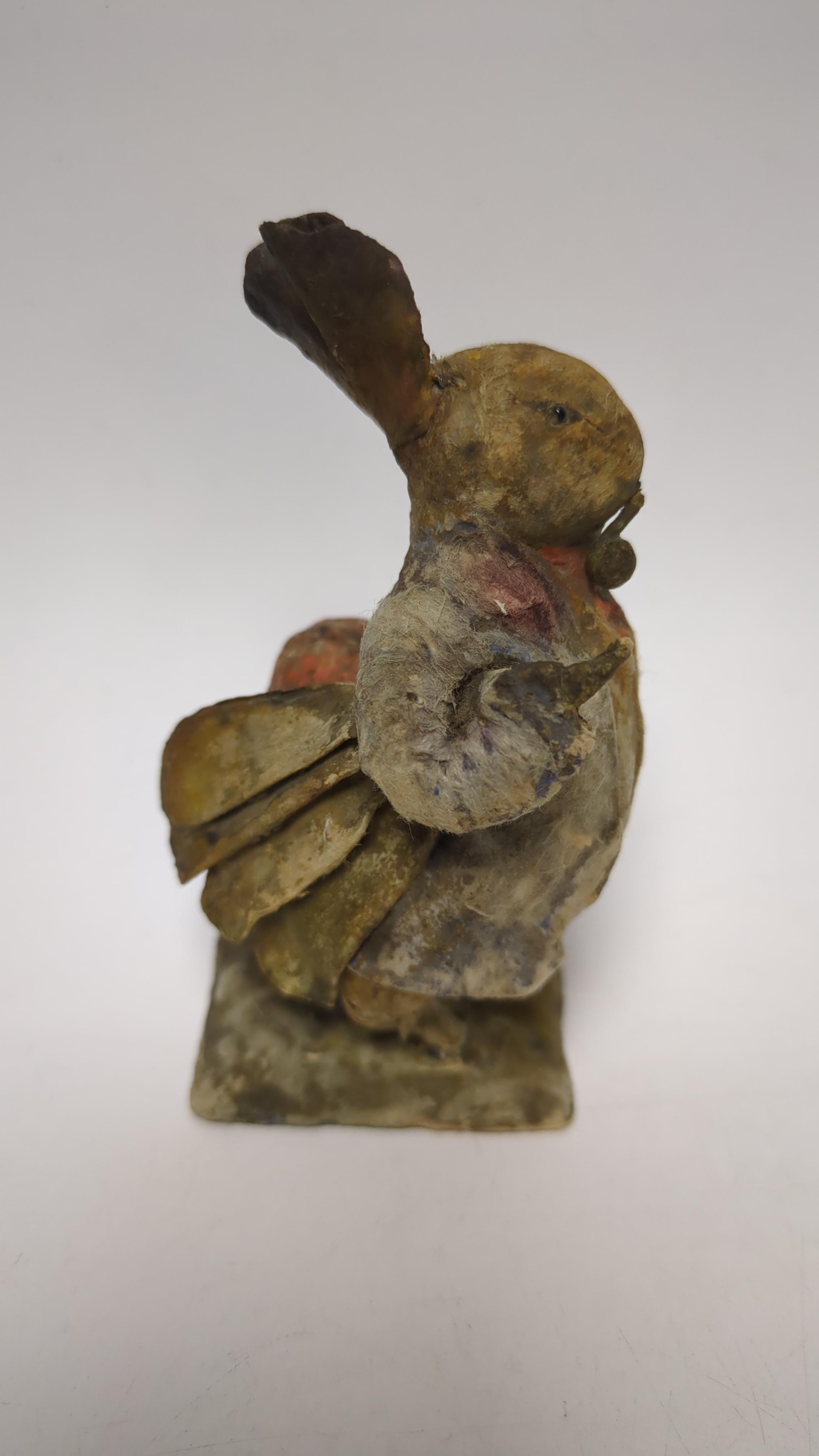 An F. Warne papier-mâché Beatrix Potter figure of Benjamin Bunny with pipe and red handkerchief bag, red and white F. Warne & Co. paper label to the base, dating it to pre-1917, 9cm high